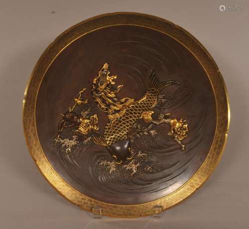 Mixed metal plate. Japan. Meiji period. (1868-1912). Decoration of Kwannon on the back of a giant carp attended by two Oni demons. Signed Nogawa. 12-1/4