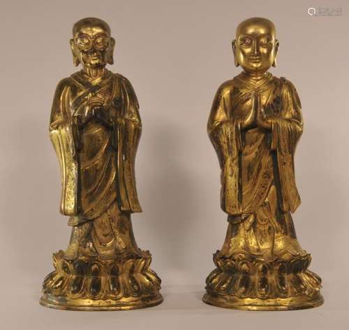 Pair of gilt bronze Buddhist figures with lotus bases. China.  10-1/2