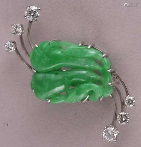 Jade and diamond brooch, in a custom platinum setting. (2 x 3.9mm, 2 x 2.9mm, 2 x 2.5mm). Near colorless, few visible inclusions. Green carved jade measures approximately 21.8 x 17mm. Overall size of brooch is 40mm x 20mm. Pin and clasp in working order. Weight of 8.4 grams.