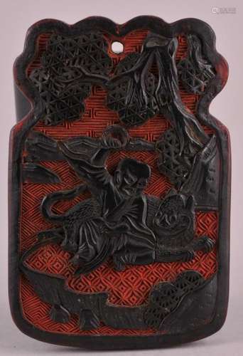 19th century Chinese finely carved black and red cinnebar pendant-plaque with figure and a dragon in landscape on one side and figure and a lion in landscape diaper background. 2-5/8