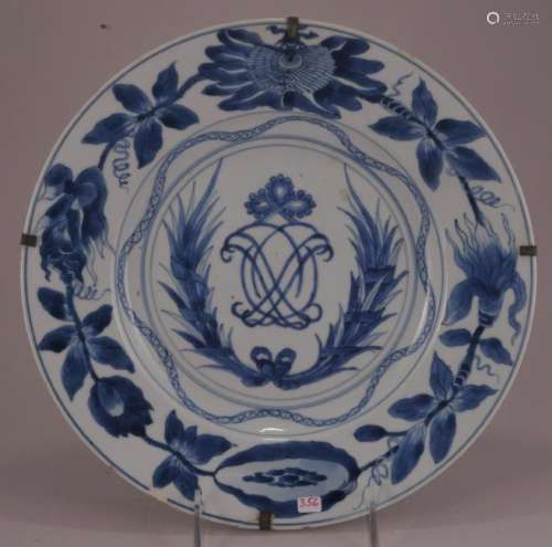 Porcelain plate. China.  18th century. Underglaze blue decoration of a floral border around a central monogram with garlands. Chip and crack.  10-1/2