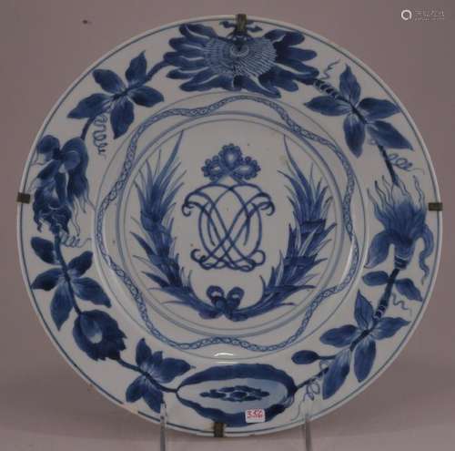 Porcelain plate. China.  18th century. Underglaze blue decoration of a floral border around a central monogram with garlands. Chip and crack.  10-1/2