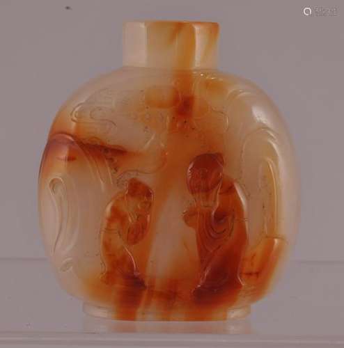 Agate snuff bottle.  China. 19th century. Surface carved in relief with two figures in a mountain grotto. Well hollowed. 2-3/8