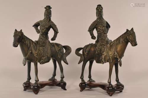 Pair of bronze equestrian warriors. China. Early 20th century. Glass inlays. Fitted stands.   10-3/8