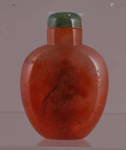 Carved carnelian snuff bottle. China. 20th century. Surface engraved with the three friends. Pine, Prunus and bamboo. 2-5/8