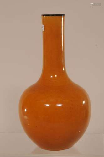 Porcelain vase. China. K'ang H si mark but circa 1900. Bottle form. Mustard colored glaze with aubergine mouth rim.  7-1/4