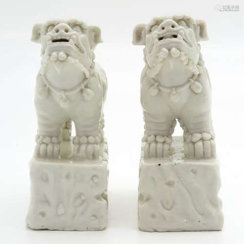 A Pair of Blanc de Chine Temple Lions 20 cm. Tall,...