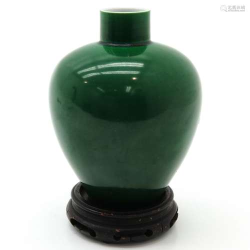 A Monochrome Vase on Carved Wood Base Green glaze,...