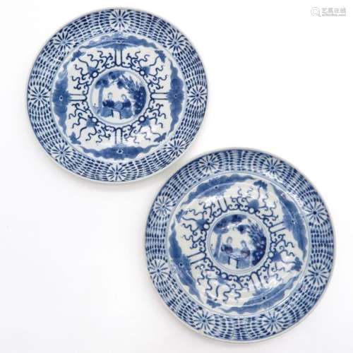 A Pair of Blue and White Plates Depicting European...