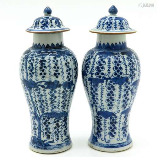 A Pair of Blue and White Vases with Covers Grape d...