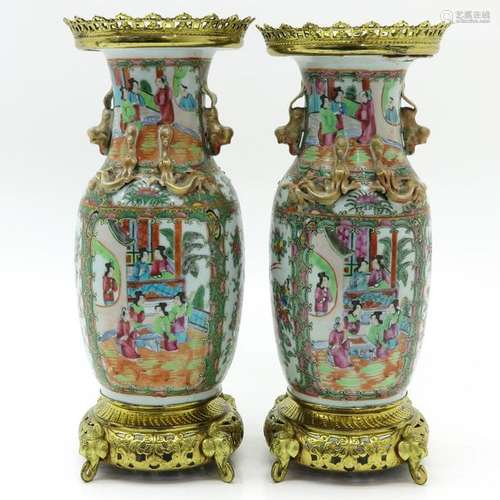 A Pair of Cantonese Vases Bronze fittings on top a...