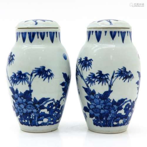 A Pair of Blue and White Vases with Covers Floral ...