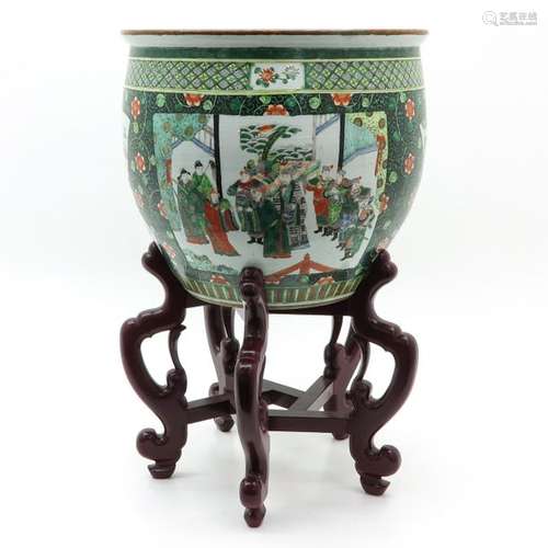 A Famille Verte Fish Bowl with Stand Depicting Chi...