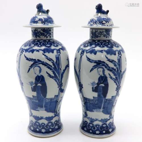 A Pair of Blue and White Garniture Vases Depicting...