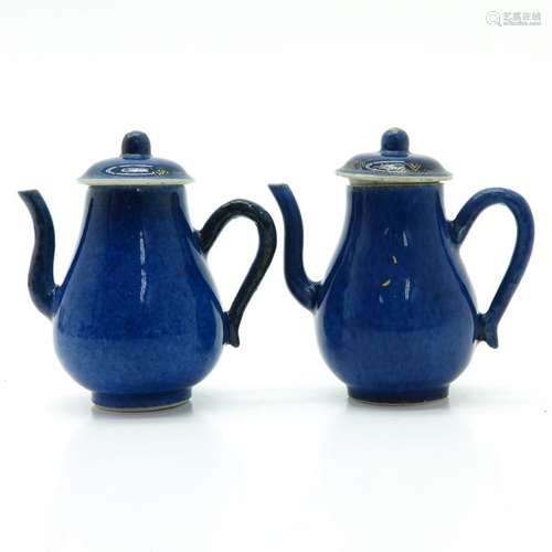 A Pair of Powder Blue Teapots Small remnants of gi...