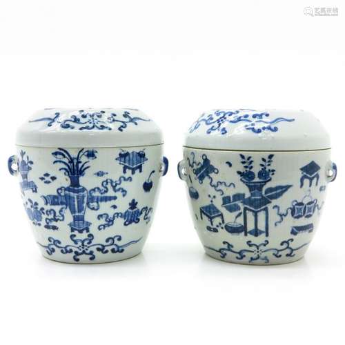 A Pair of Blue and White Decor Covered Jars Depict...