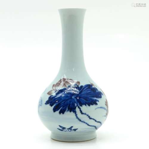 A Blue and White and Red Vase Depicting flowers an...