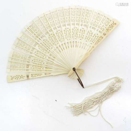 A Carved Chinese Fan 20 x 13 cm. This lot may not ...