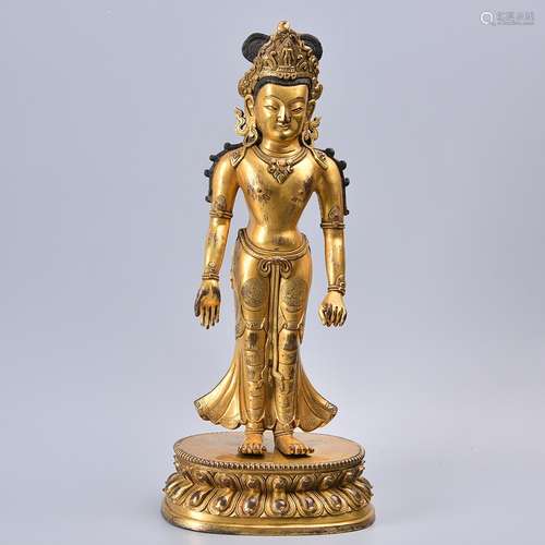 A GILT-BRONZE FIGURE OF STANDING BUDDHA