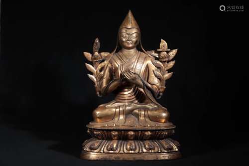 A GILT-BRONZE FIGURE OF GURU