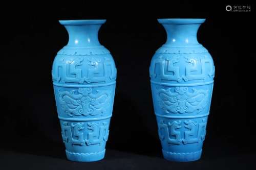 A PAIR OF BLUE GLASS CARVED VASES