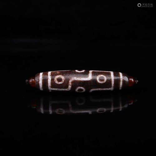 A TIBETAN 9-EYE CINNABAR DZI BEAD