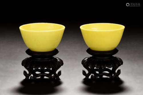 PAIR OF LEMON YELLOW GLAZED CUPS WITH WOODEN STANDS