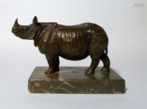 A Patinated Bronze Figure of Rhinoceros on marble stand.