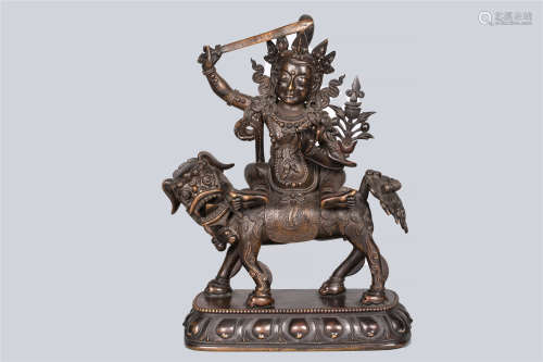 A Patinated Bronze Figure of Manjushri riding a Dragon, China, Ming Dynasty.