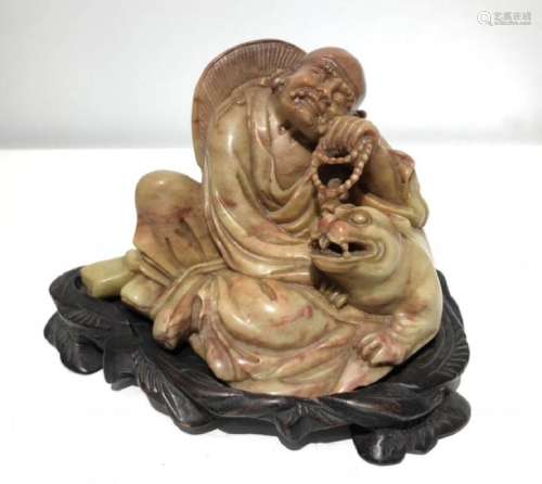 A SOAPSTONE CARVED LUOHAN FIGURE