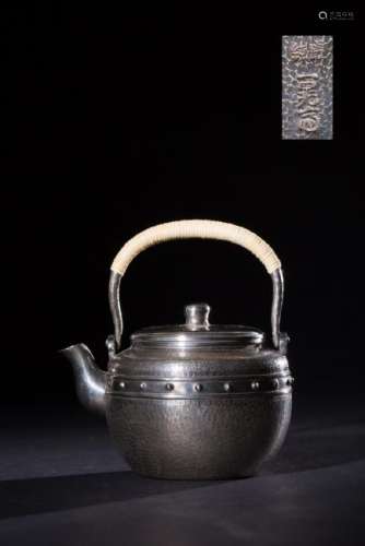 A SILVER MOLDED HANDLE WATER POT