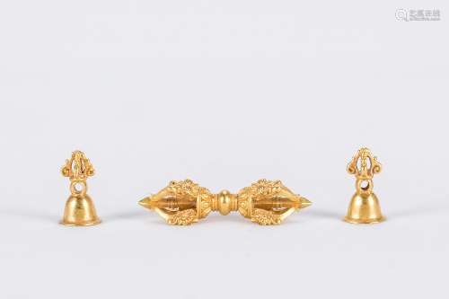 Three gold Buddhist pieces.
