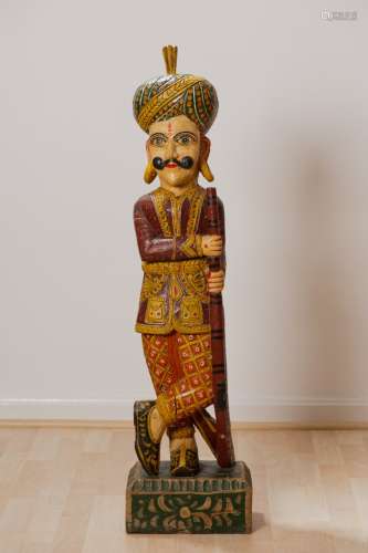 Vintage India Chowkidar wooden 42 in Military statue Indian Chowkidar wooden hand carved / colorfull painted 42 in H X 11 in W base. Night watchman / guard holding on old riffl. The sculpture weighs 28 pounds. It is a winderful decorative piece. The guard is wearing beautifully painted rural ornament clothing and a turban. It is carved from a single piece of wood. There is  crack in the wood.