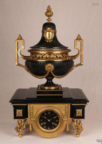 Napoleon III mantel clock with vase top - France 2nd half of the 19th century, 2 pcs,<br />marble Noir / Belgian marble, massive rectangular base case in black stone with magnificent fire-gilt bronze ornamentation, artfully designed feet in the form of fully plastic flower vases on spindle stand, center front and back mounted Lambrequin pendant with engraved bee motifs,  round black dial with gilded Roman hour numbers and pointers under faceted glazing, dial in the lower segment signed ''F.Barbedienne Paris'', above a fully plastic large foot vase of appropriate material with gilded bronze implements and fittings, removable lid, laterally angular high-drawn handles, bronze montur (vase) signed ''F.Barbedienne'', engraved with Arabesque motifs, half hour and hour strike on bell, movement and pendulum of the same number, stone edges partially with small chips and bumps, small damage on the edge of the lid, stepped plate with traces of use (abrasion and scratches), functions perfectly, key and pendulum attached, base dimensions: ca.22,5x38x26,5cm / H. vase ca.46cm / total weight ca.40 (!) kg Shipping only with forwarding!