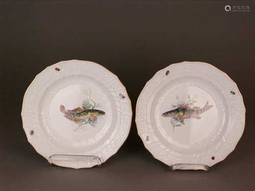 Two fish plates Meissen - underglaze blue  sword mark, Knauf time, ca 1860, Brandenstein<br />relief, polychrome painted with fish and aquatic plants in the well and insects in the edge, gold rim, Nr. 82, slight signs of use, gold rim rubbed, D.ca.25cm