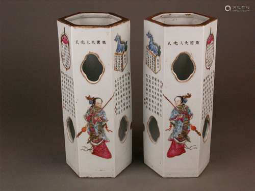 Pair of porcelain famille rose hatstands/lanterns - of hexagonal form, having a pierced<br />body, porcelain painted in overglaze enamels with depictions of mythological figures wearing opulent robes (four different figures) and various verses, red seal mark to base ''Da Qing Tongzhi Nian Zhi'' - ''Great Qing Tongzhi (1862-74) Period Make'', but probably Guangxu (1875-1908) period or somewhat later, China, gold paint partly rubbed or darkened, H.c. 28.7 cm/ c.11,3 in.