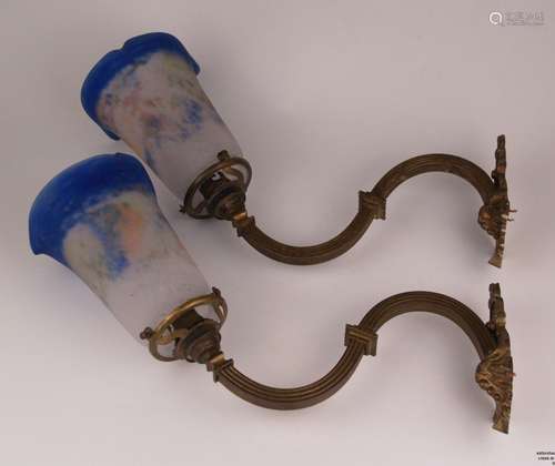 Pair of wall lamps - ''Noverdy France'', curly metal arms, bell-shaped glass shades,<br />milky opaque with blue and orange powder melts, single-flame, electrified, depth of the lamp: ca.35cm, glass D.ca.10,7cm, holder H. ca.13,5cm, holder B.ca.6,5cm, slight traces of age or use