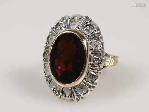 Lady's ring with garnet and diamonds - 500er gold / 800er silver, faceted, garnet in bezel<br />setting (ca.12,4 x 9 mm) surrounded by 12 diamonds in silver setting (each ca 2.7mm), inner diameter: ca.18.3 mm , ring head size: approx. 23.2 x 17 mm, weight: approx. 8.9 g, hallmarked: 500/800/330 NA (Naples Italy).