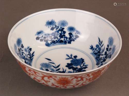 Red and Blue'Baijixiang' Bowl - China, mark of Daoguang, rising from a short tapering foot<br />to a slightly flared rim, densely decorated with scrolling lotus blooms interspersed with the Eight Buddhist Emblems, the bajixiang, inside bloooming flowers, the base inscribed in underglaze blue with a zhuanshu six-character reign mark, h.appr.6cm(2.4in.)/dm.ca.14,5cm(5.7in.)