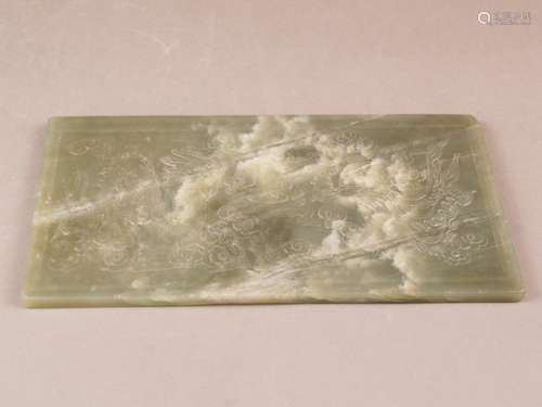 Large rectangular jade plaque - celadon-green jade slightly cloudy with beige color<br />inclusions, dragon and phoenix among lingzhi clouds, ca.5,5x22,5cm, ca.533g