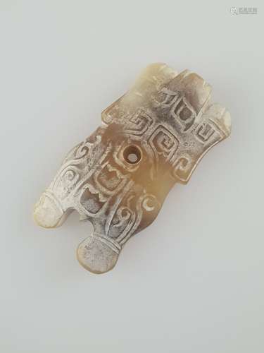 Jade 'turtle' amulet - China, probably Shang Dynasty, circa 1800-1100 BC, Henan Province,<br />whitish jade with brown inclusions and veining, top with archaic ornamental decoration, smooth underside, round drilling to centre of the body, c.7x3,8cm, weight c.74g, the turtle (gui) belongs in China together with the dragon (long), the phoenix (fenghuang) and the quilin to the ''Four Divine Creatures'', symbollicaly it represents considered the universe, according to an old myth when the pillar supporting the heavens was damaged due to a violent feud between gods, the creator goddess Nüwa, who molded humans from clay, pittied them all and used the four legs of a giant turtle to form new pillars to support the sky. But she didn't do it perfectly because the unequal length of the legs made the sky tilt. The reason that western China is mountainous and the east lower is because she used the longer legs of the tortoise to support the west and the shorter ones for the east