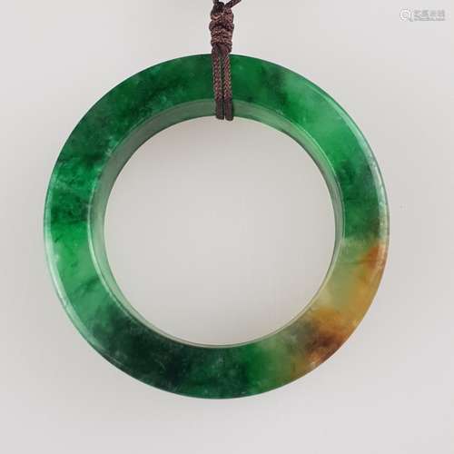 Large ring-shaped Nephrite Pendant - China, Qing-dynasty,carved nephrite jade with green<br />and brownish color inclusions, polished, attached to a dark brown cord, dm.c.5,5cm / weight c.48g