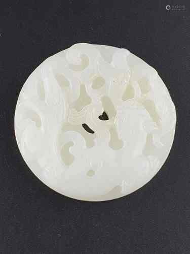 Round jade ''Bi''carving  - finely carved white jade, one side featuring the creeping<br />chi-tiger in bas-relief, the other engraved archaic ornament pattern,edges partly somewhat uneven, dm.c.5cm, China 20th century.