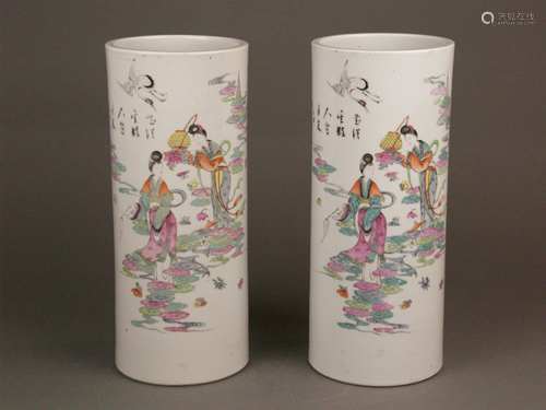 Pair of  ''Famille-Rose''-Hatstands - China 20th century, early republic period, cylindrical<br />shape, porcelain, obverse side painted in polychrome enamel colors: mythological scene with the goddess of long life Magu, who presented a flower basket to goddess Xi Wang Mu (the Queen Mother of the West) on the occasion of her 1000th anniversary celebration, Chinese calligraphy lettering, four-character Kaishu mark  'Fu xing chang zao', H.ca.28,8cm