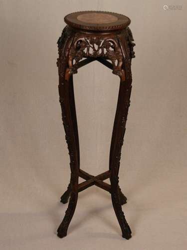 Flower Stand - China, wood, carved with blossoming plum branches, raised on  four high<br />curved feet, top with inlaid small marble panel of round shape, signs of age and wear, applied carvings partly damaged, H: c.90cm,dm(top). c.26cm