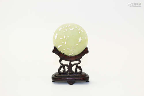 Chinese celadon jade plaque on a wood stand