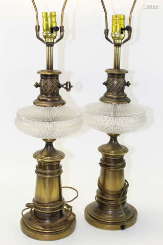 A pair of brass and glass lamps.