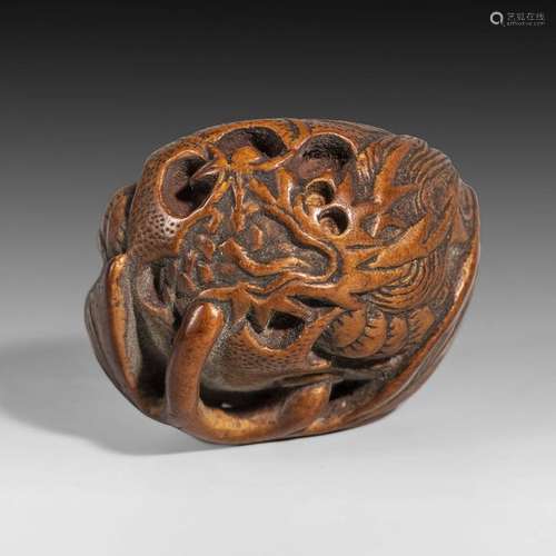 Netsuke en bois représentant un dragon enroulé dan...