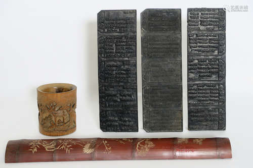 Chinese brushpot in bamboo with finely sculpted scene, three antique Chinese printing blocks and a Chinese wrist rest (used during painting) in bamboo with polychromy