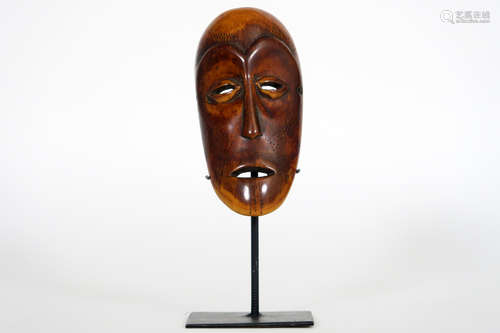 African Congolese ‘Lega’ sharm in the shape of a mask in ivory with the typical Lega characteristics